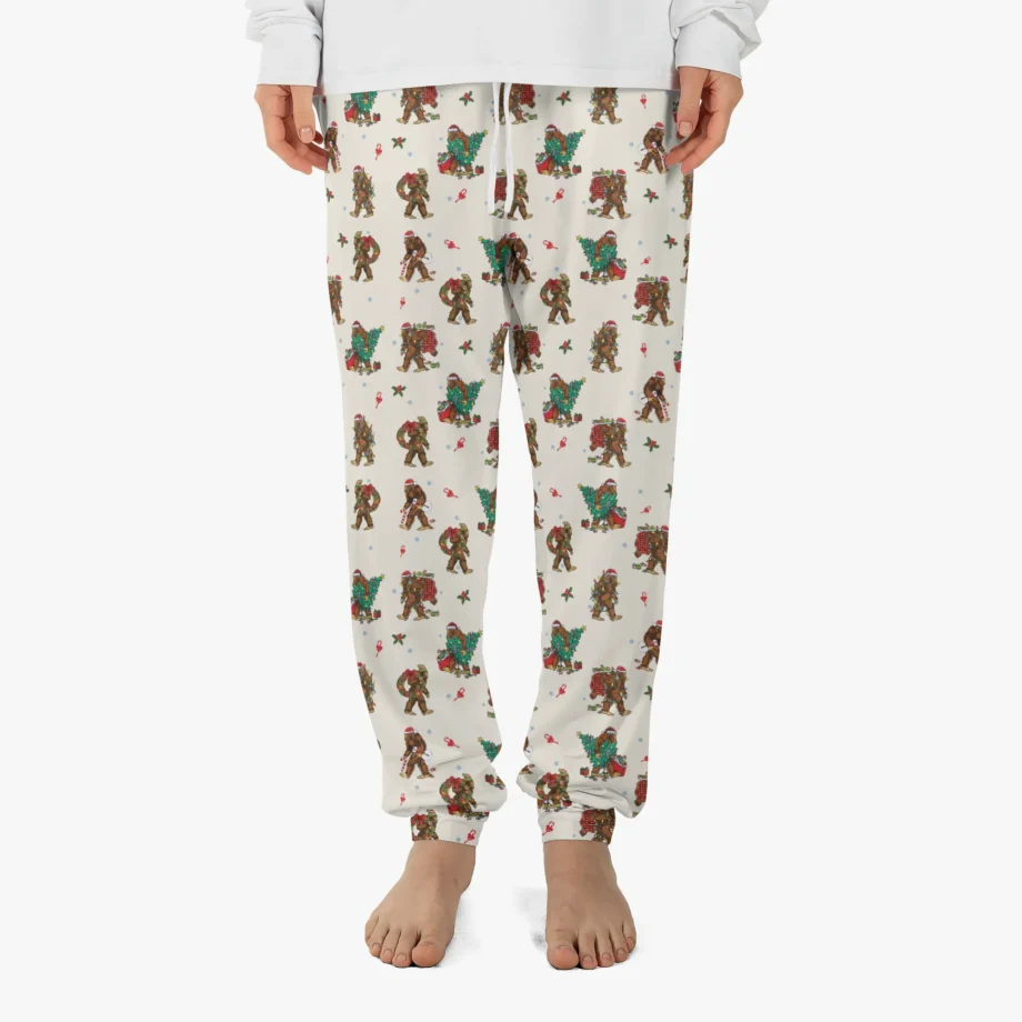 Bigfoot pajama pants with Sasquatch carrying Christmas trees and holiday decorations