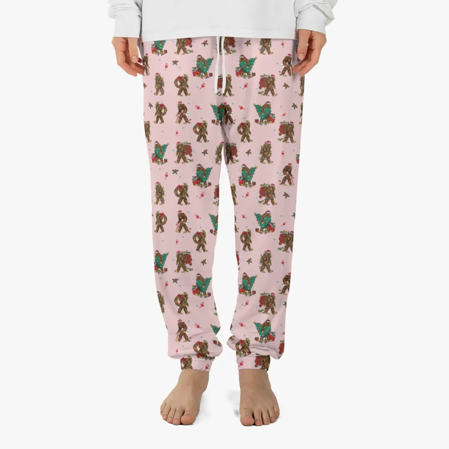 Bigfoot pajama pants with Sasquatch carrying Christmas trees and holiday decorations