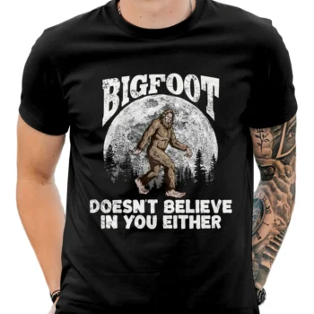 Bigfoot 'Doesn't Believe in You Either' shirt with forest and full moon design