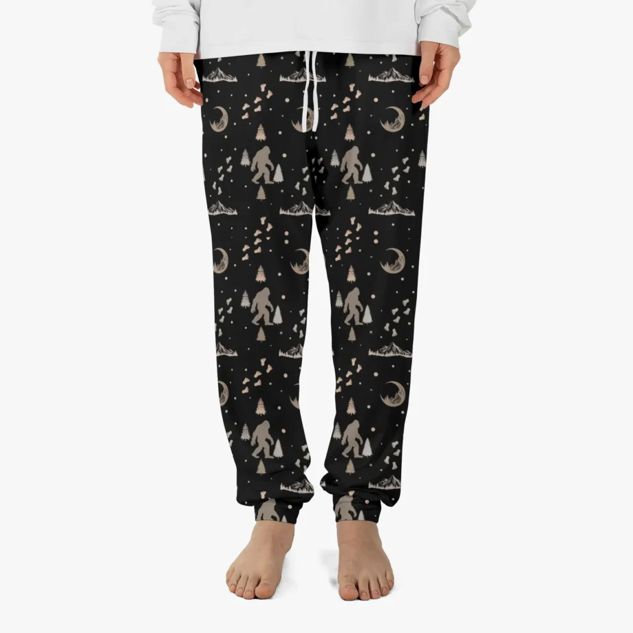 Bigfoot pajama pants with Sasquatch footprints and festive holiday design