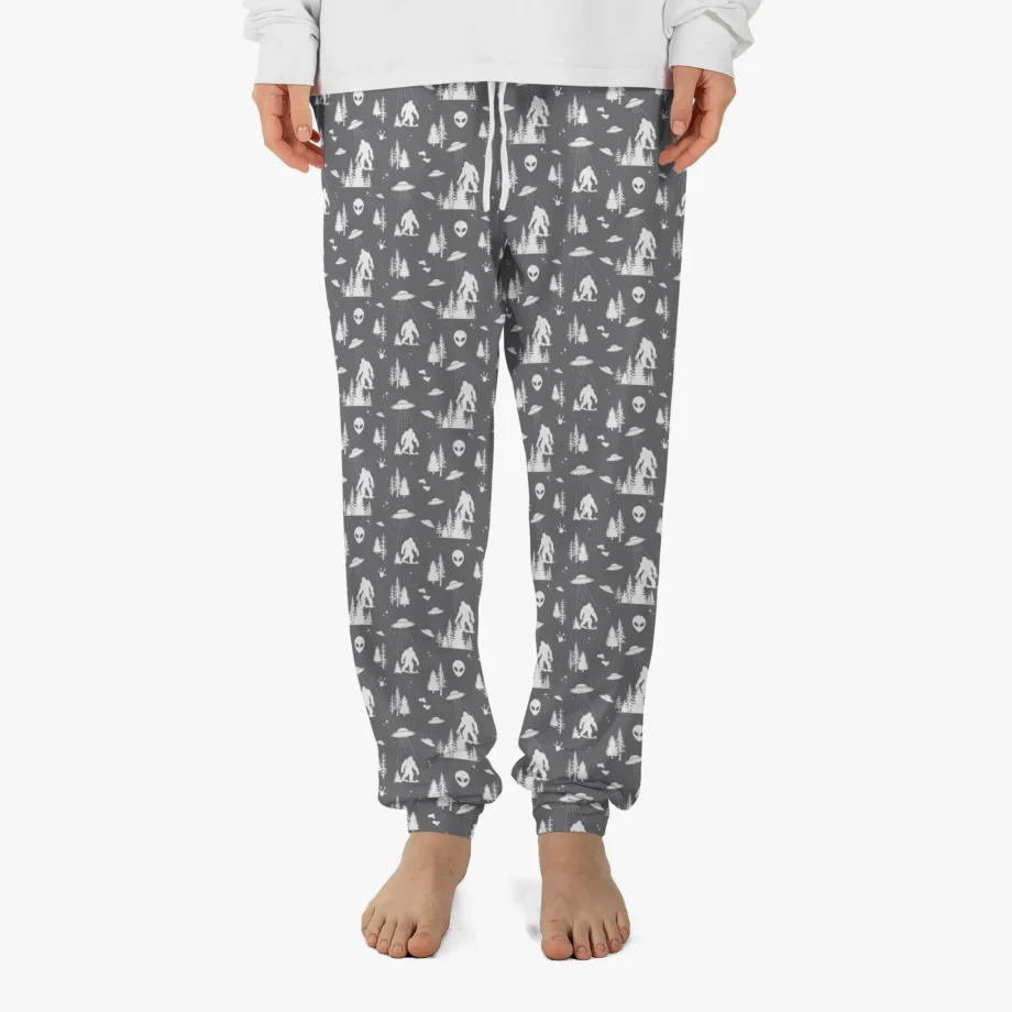 Bigfoot pajama pants featuring Sasquatch, UFO, and alien print on green fabric