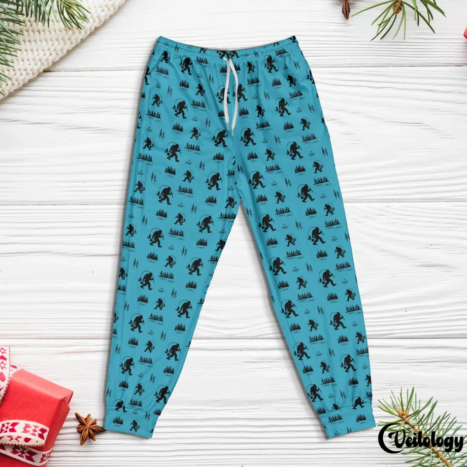 Bigfoot lounge pants with fishing theme and Sasquatch silhouettes on green fabric