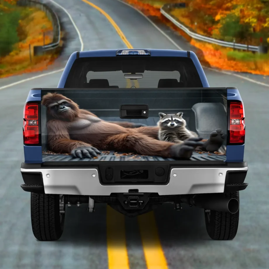 Bigfoot raccoon truck tailgate wrap with a funny Sasquatch lounging design for vehicles