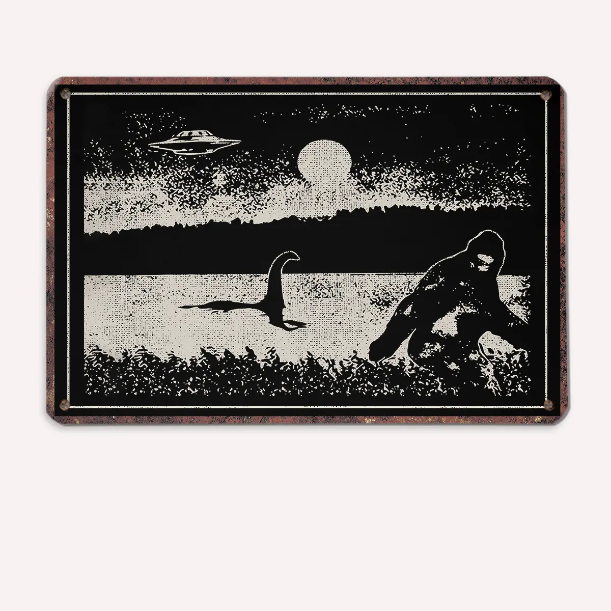 Vintage-style metal sign in black and white featuring Bigfoot near a lake, with the Loch Ness monster in the water, a UFO in the sky, and a full moon in the background