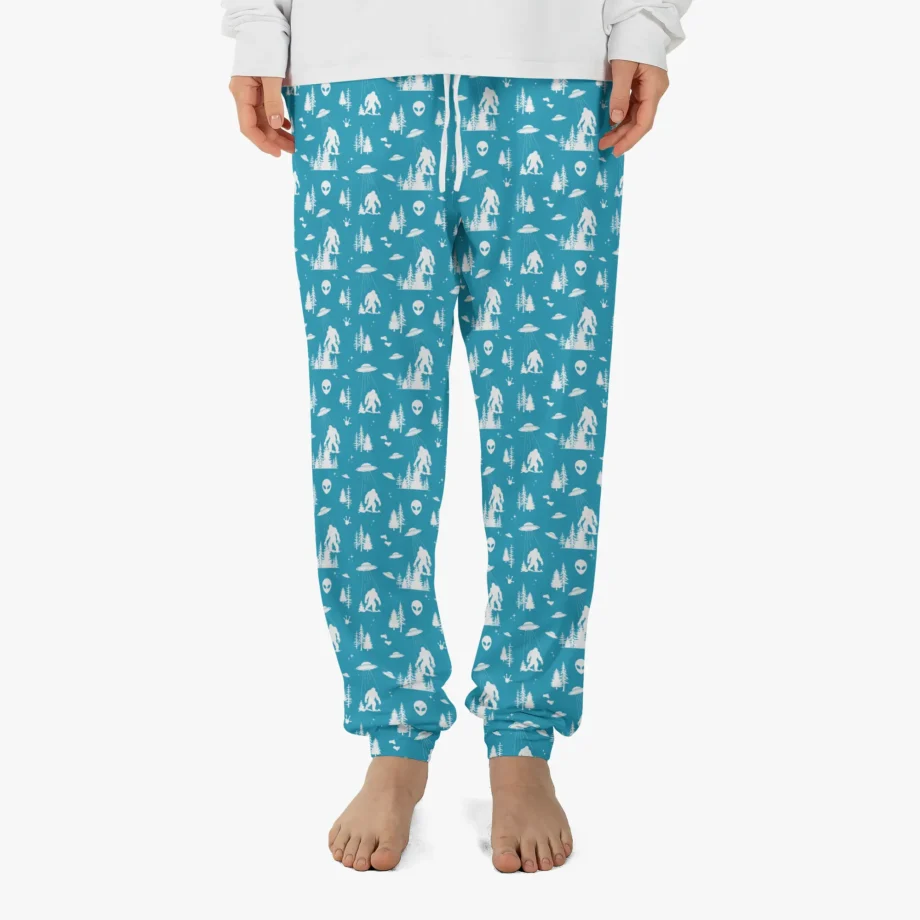 Sasquatch lounge pants with alien, UFO designs on forest green fabric