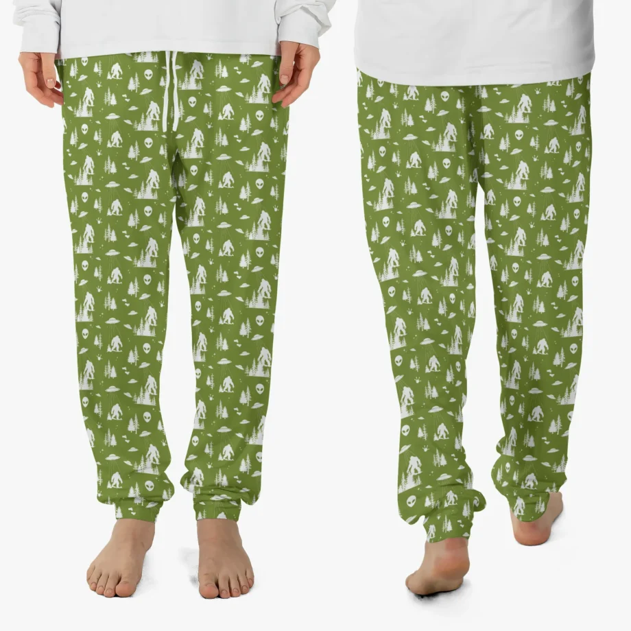 Bigfoot pajama pants featuring Sasquatch, UFO, and alien print on green fabric