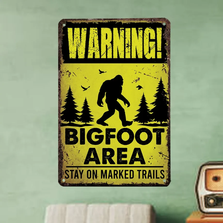 Warning Bigfoot Area sign with yellow background and 'Stay on Marked Trails' message