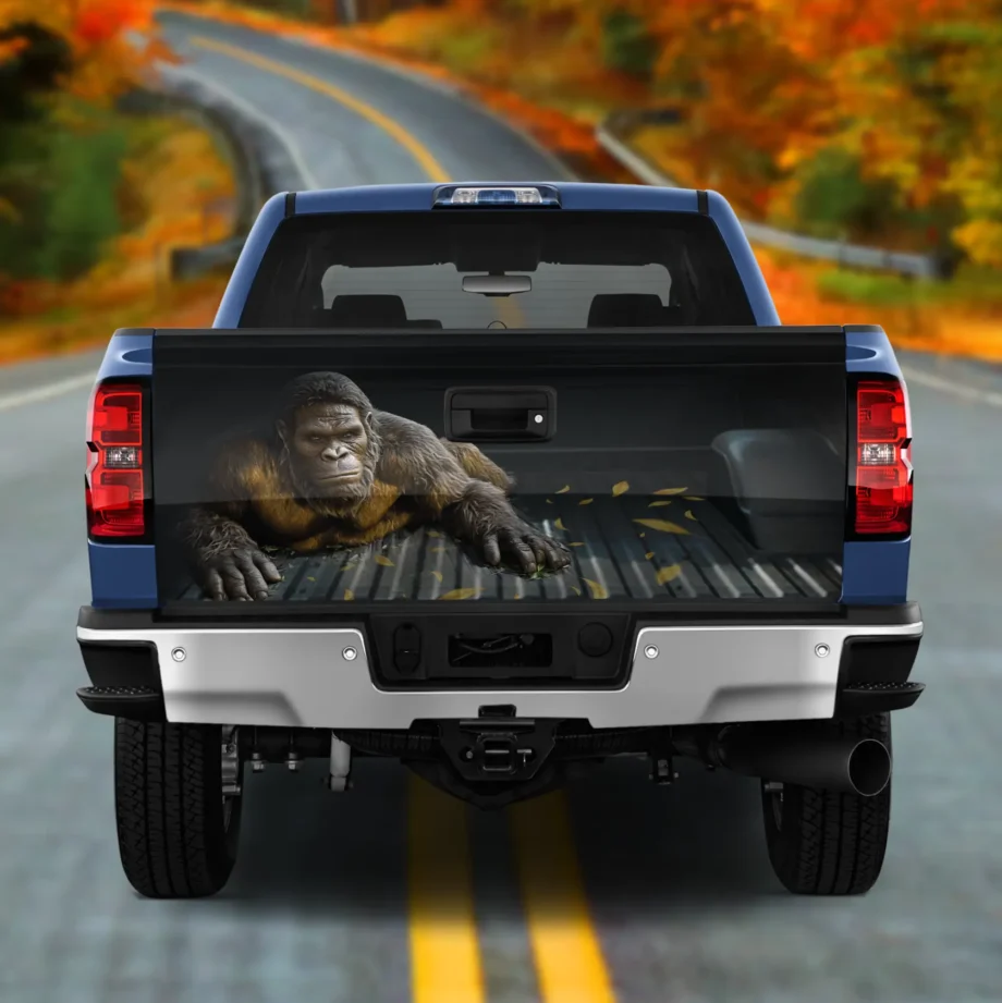 Funny Sasquatch tailgate wrap with realistic Bigfoot crawling design for outdoor car decor