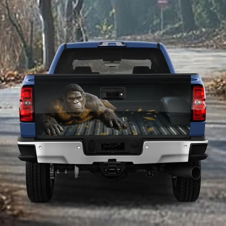 Realistic Bigfoot tailgate wrap decal with lifelike Sasquatch crawling design for truck decor